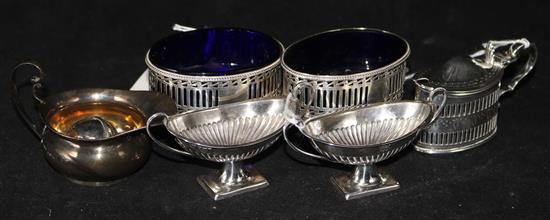 A pair of George III pierced silver oval salts with blue glass liners, a pair of later salts, a mustard, a small jug and a pepper